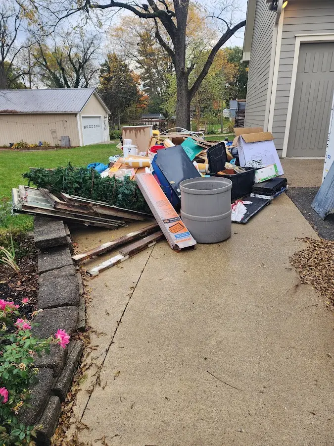 Dumpster being loaded with debris for Estate Cleanout Dumpster Rental in Sienna